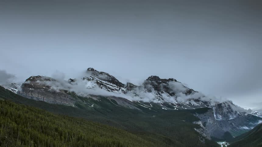 Clouds twisting above a mountain