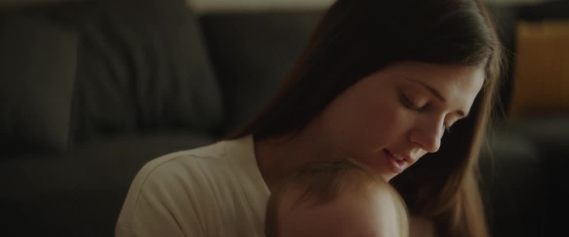 A mother kisses her son at home