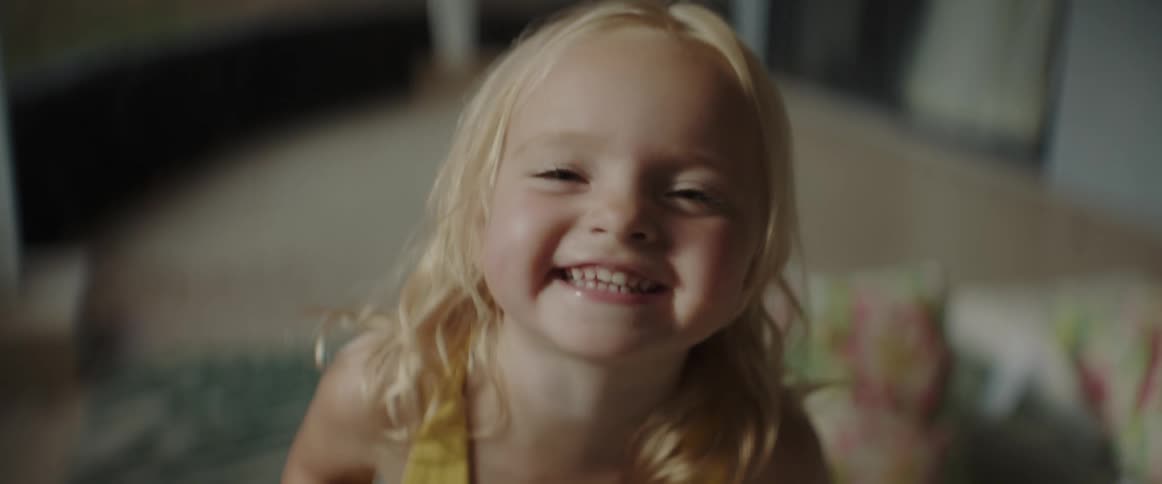 A little girl is laughing and sticking her tongue out
