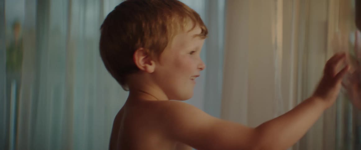 Brother and sister are playing near a door