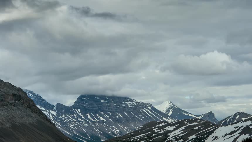 Clouds floating over some mountains