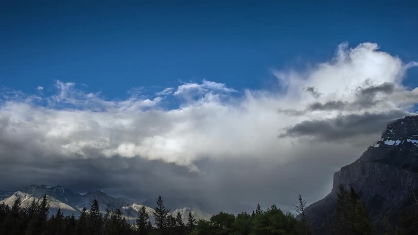 Clouds roll over mountain top