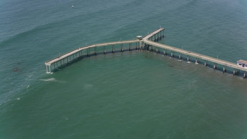 Aerial view of a dock over the ocean water is displayed