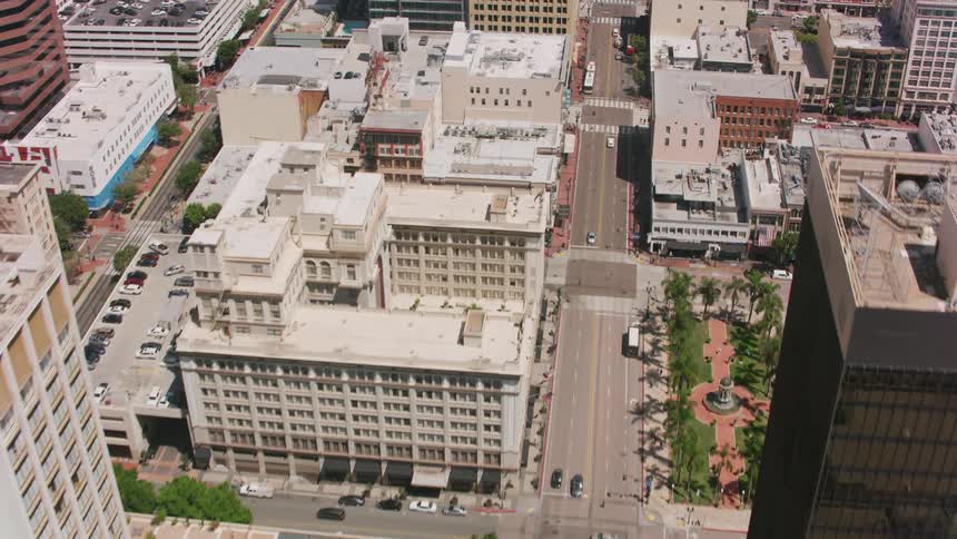 Aerial view over downtown with traffic on the streets among buildings and skyscrapers