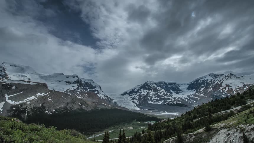 A mountain range covered with snow is in the distance