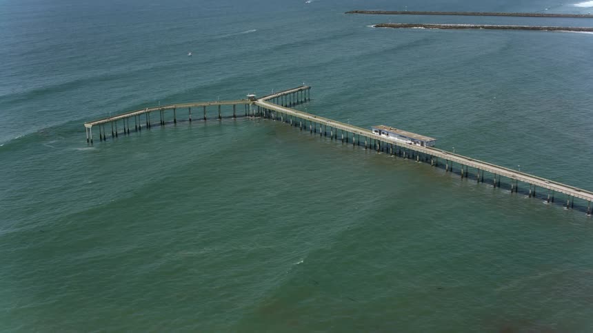 An aerial view of a pier in the ocean