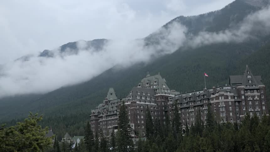 Fog rises from a mountain forest
