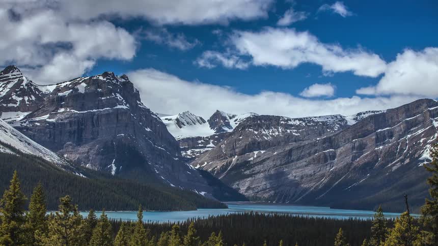 Clouds pass over a mountain lake