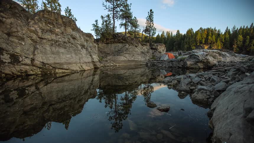People camping near a small lake