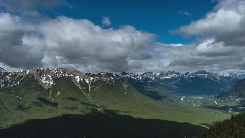 Time lapse of clouds traveling above a mountain range