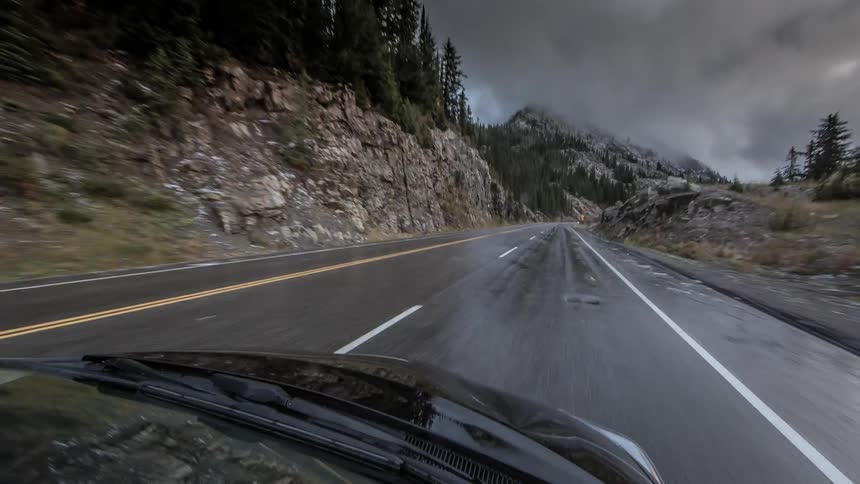 Time lapse of a car moving down a twisting road
