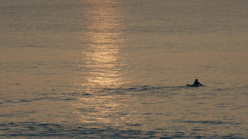 A person is surfing in the water