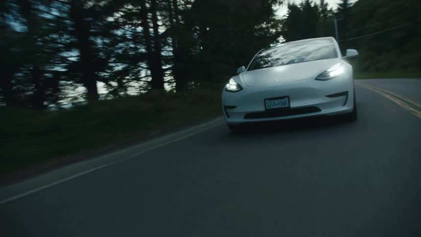 A car driving on a road along the coast