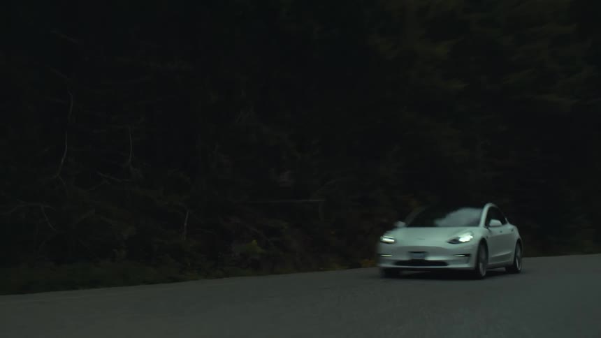 A car travels on an empty mountain road