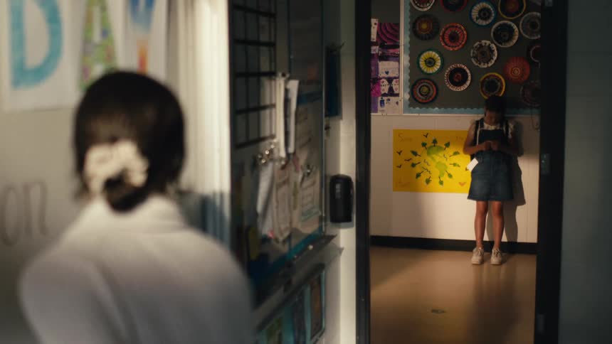 A teacher and a student are in a classroom