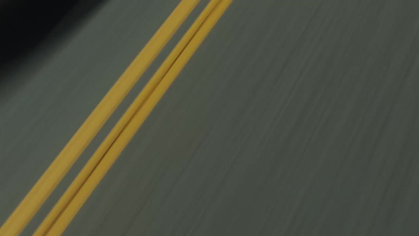 Close up view of a street with two lanes is displayed