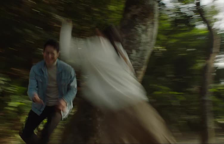 Speed up footage of fathe and daughter playing around the trees in a park