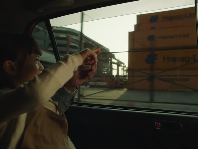 People point from the car towards the port