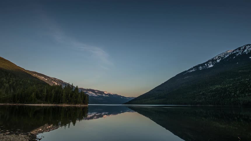 The sun setting near a still lake