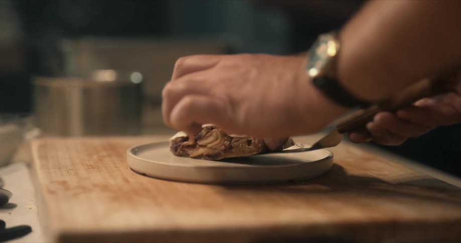 A chef putting food onto a plate