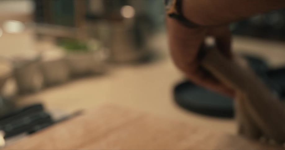 A person cleaning a knife in a kitchen