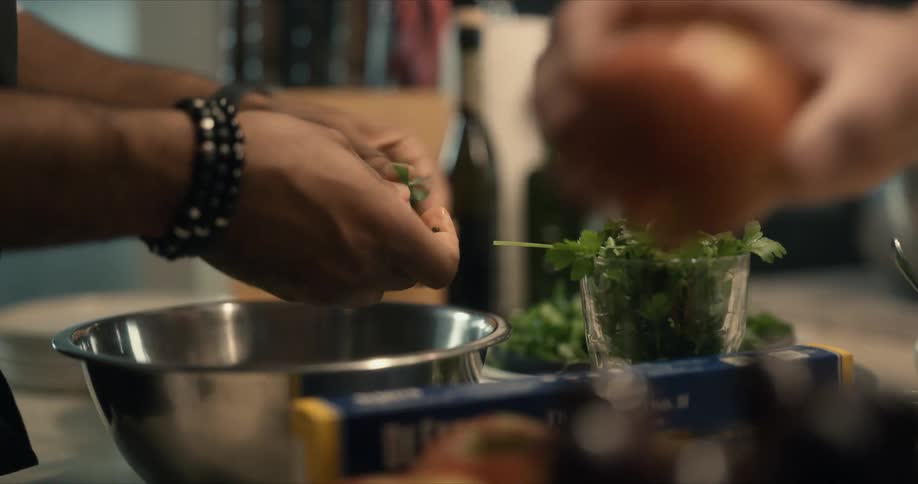 Two men prepare produce in a kitchen
