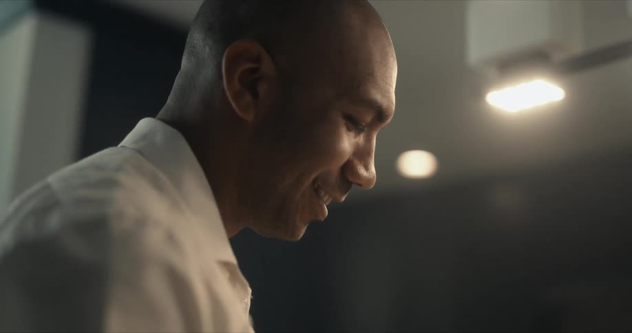 A man with a smile on his face working in a room
