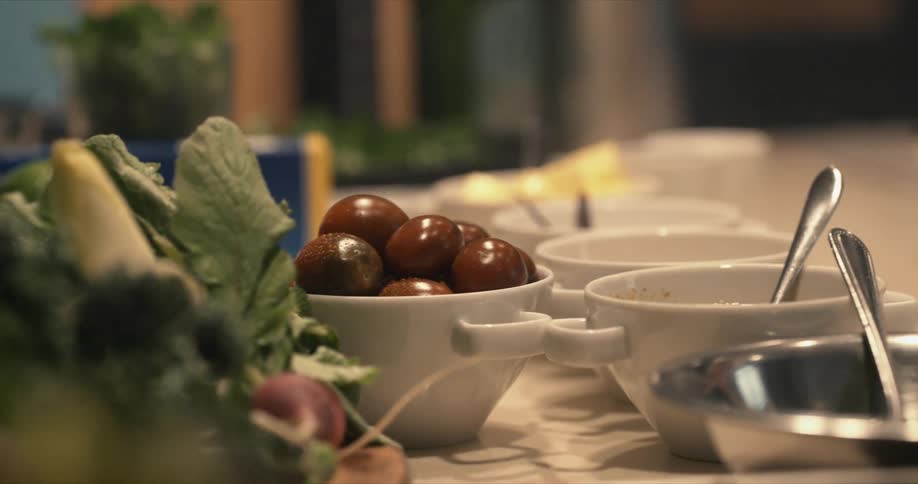 Bowls of fruit and vegetables sitting on a kitchen counter