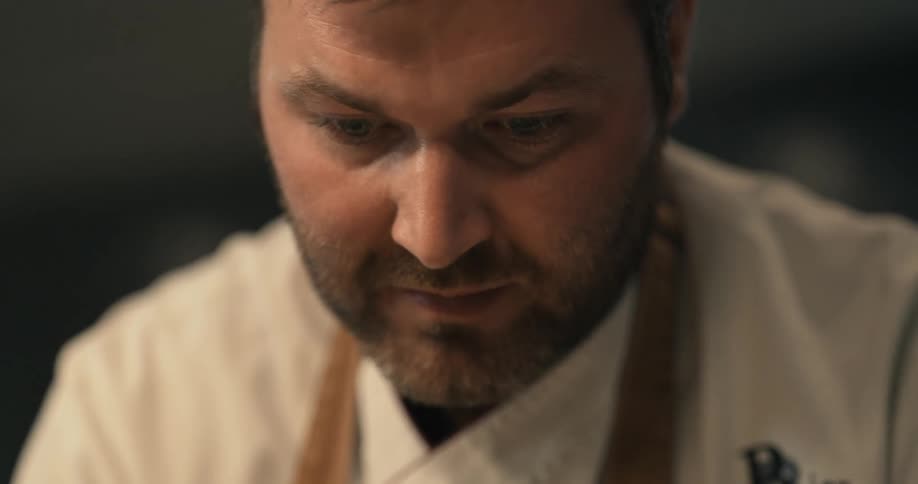 A chef is concentrating as he cooks