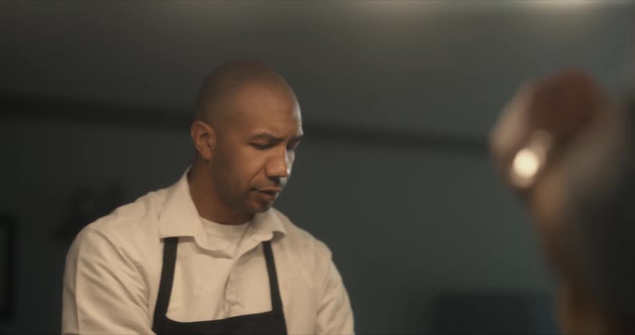 Chef talks while cooking food on the restaurant kitchen