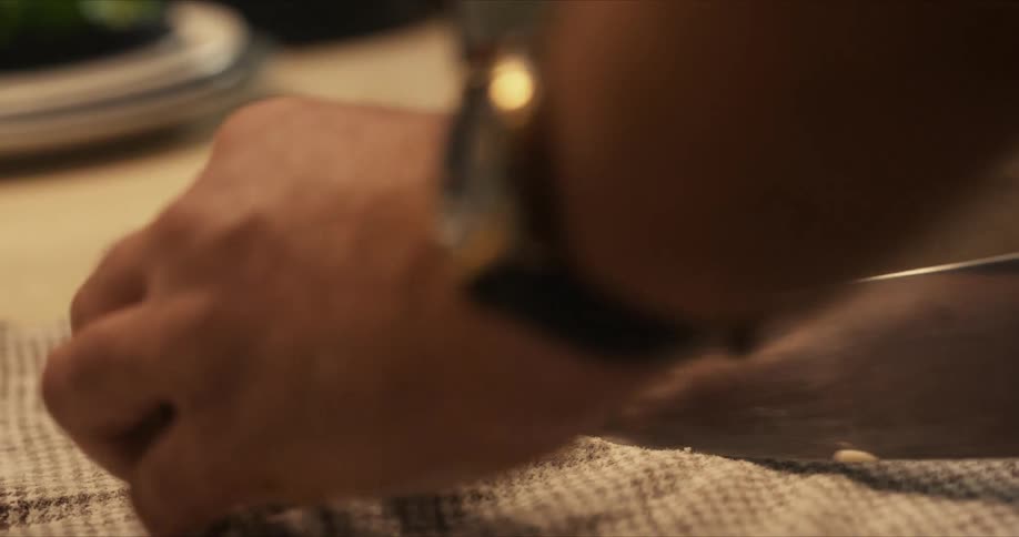A man cuts a piece from a roll of dough