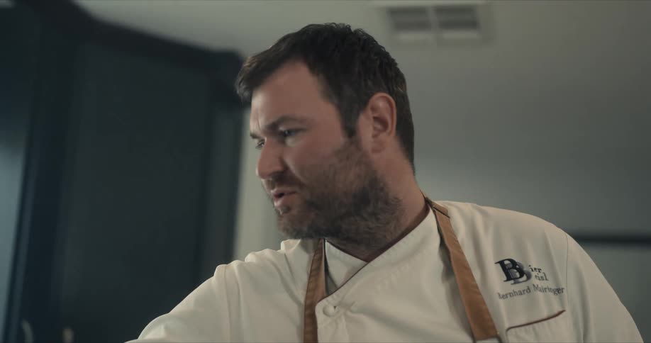 Chef talking to someone while cooking at home