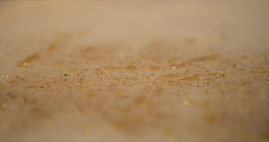 Oil is sprinkled on the dough