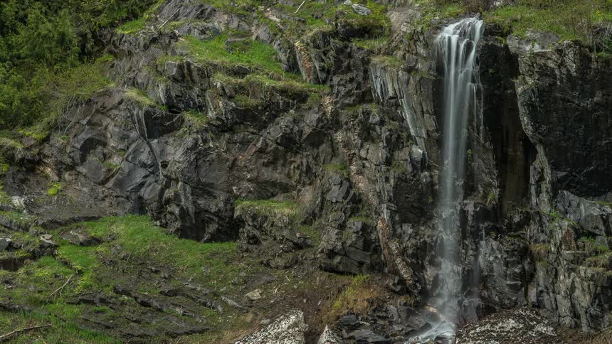 Water cascades over a rocky cliff