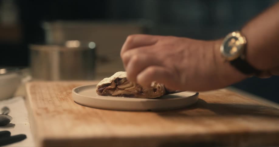 A man plates food in a kitchen