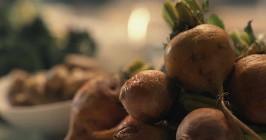 Plates of cooked beets and other vegetables over a table at home