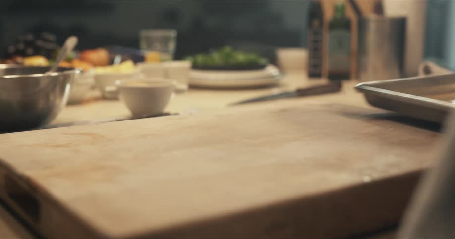 Male chef picks up a coated dish with melted butter
