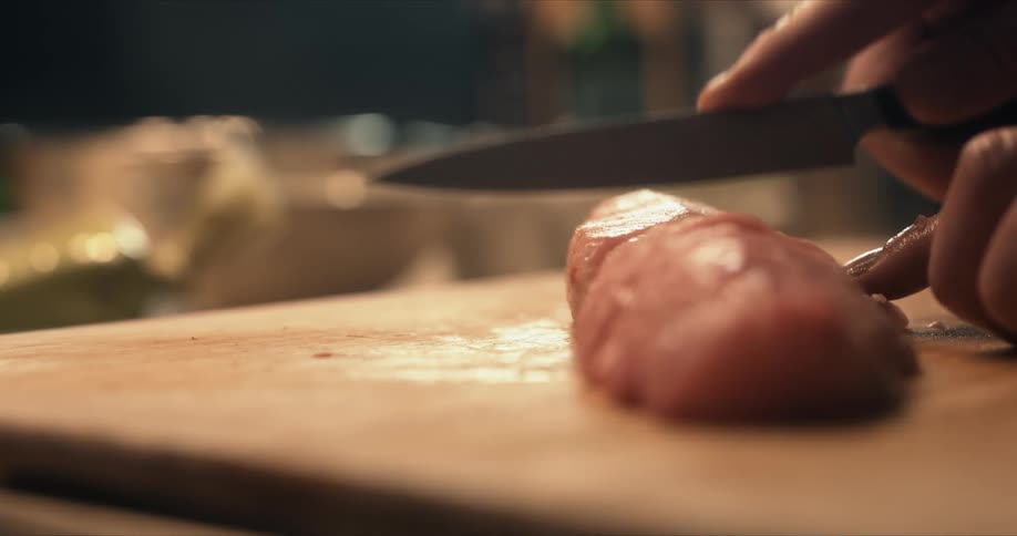 A person is cutting raw fish