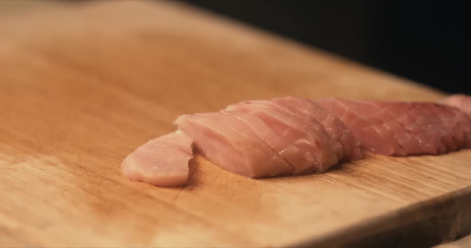 A sliced fish is on a cutting board