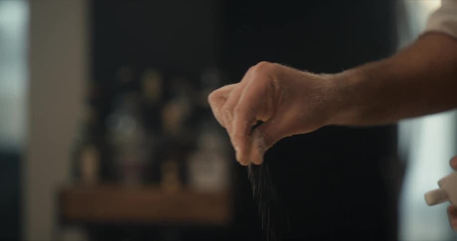 Man spreads a pinch of salt as seasoning