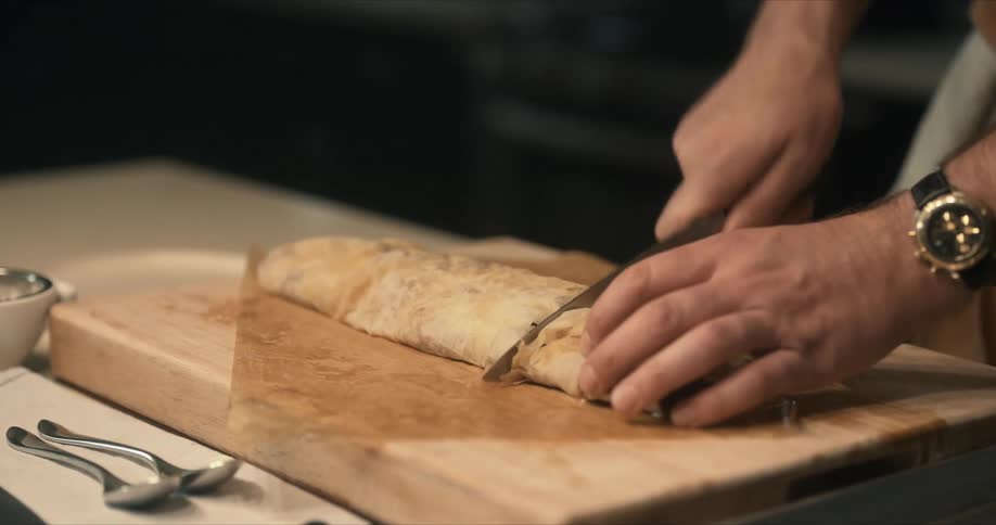 A person is cutting food on the cutting board