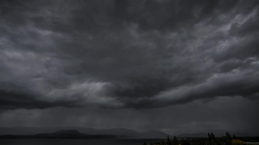 Storm clouds move around and pour rain below