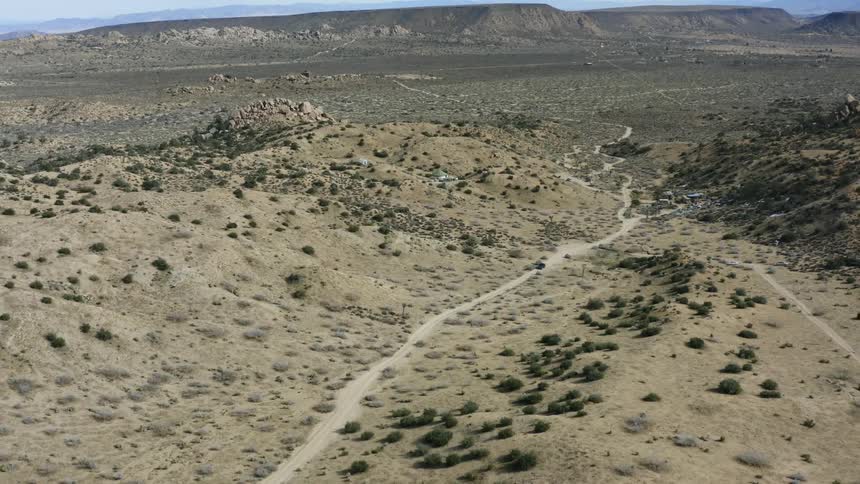 A car drives in the dirt road