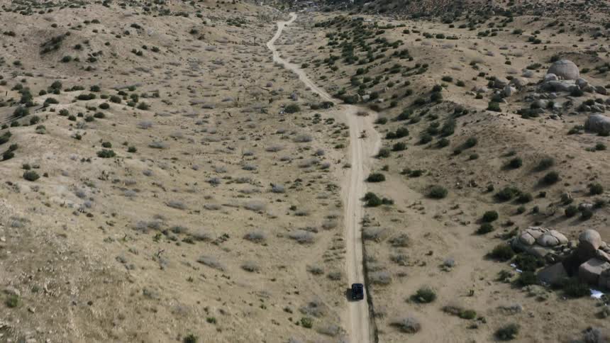 A car drives in he desert
