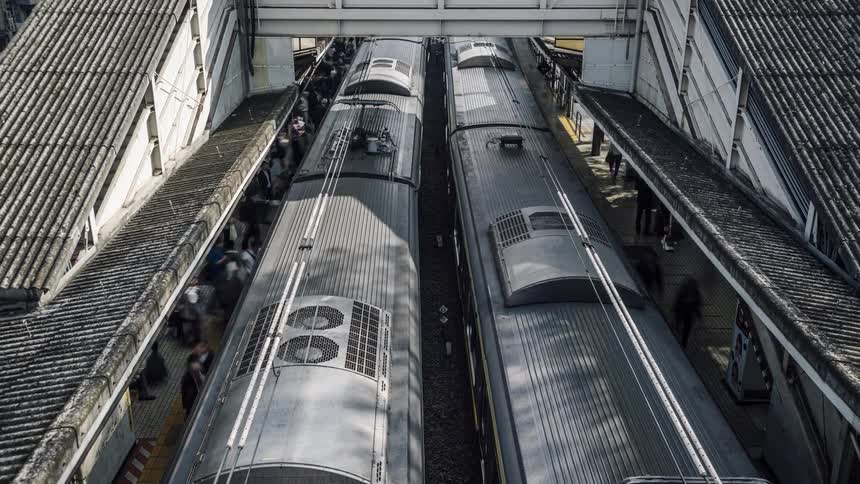 Train stops in the terminal and the waiting passengers on the platform get on the train