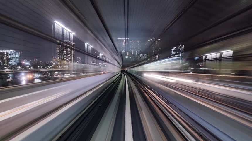 The train moves around the tracks through the city