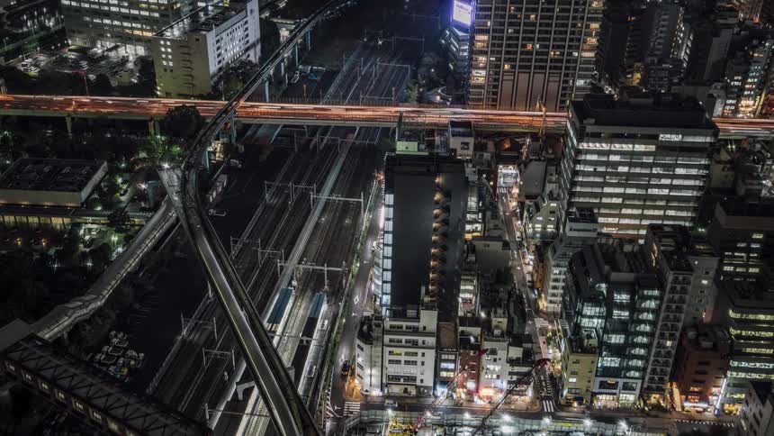 Vehicles move through the lit city at night
