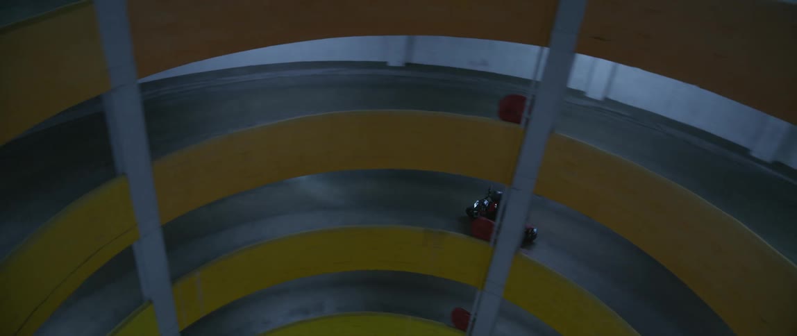 Motorcycle travels around a circular bend inside a building