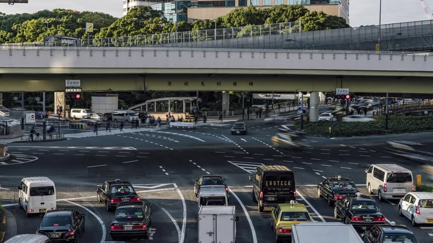 Vehicles are traveling on the roads near the overpass