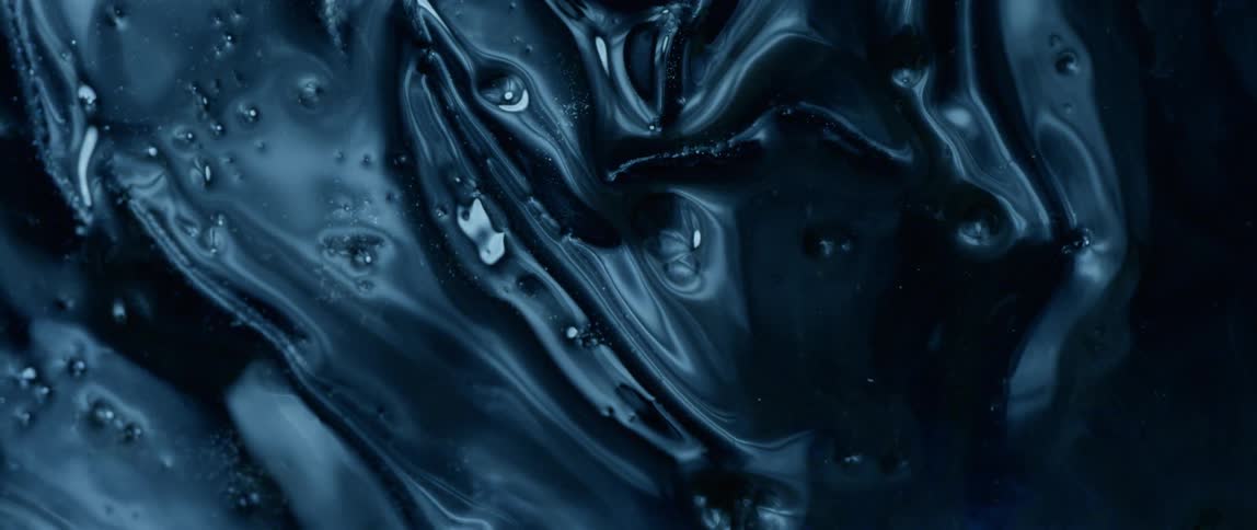 A drop of water moves down the ice